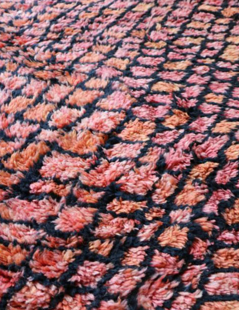 Detail of the hand-knotted fringe on a natural wool Moroccan carpet