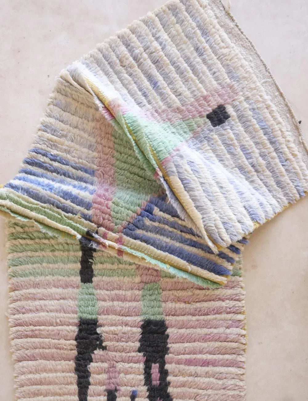 Multicolored textured rug on a light background
