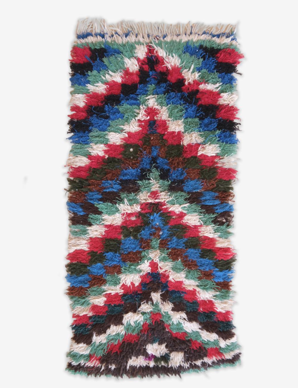 Multicolored woven rug with a geometric pattern on a white background
