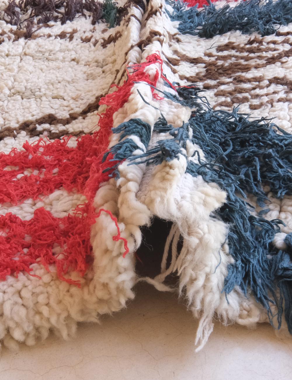 Close-up of a textured fabric with red, white, and blue colors.