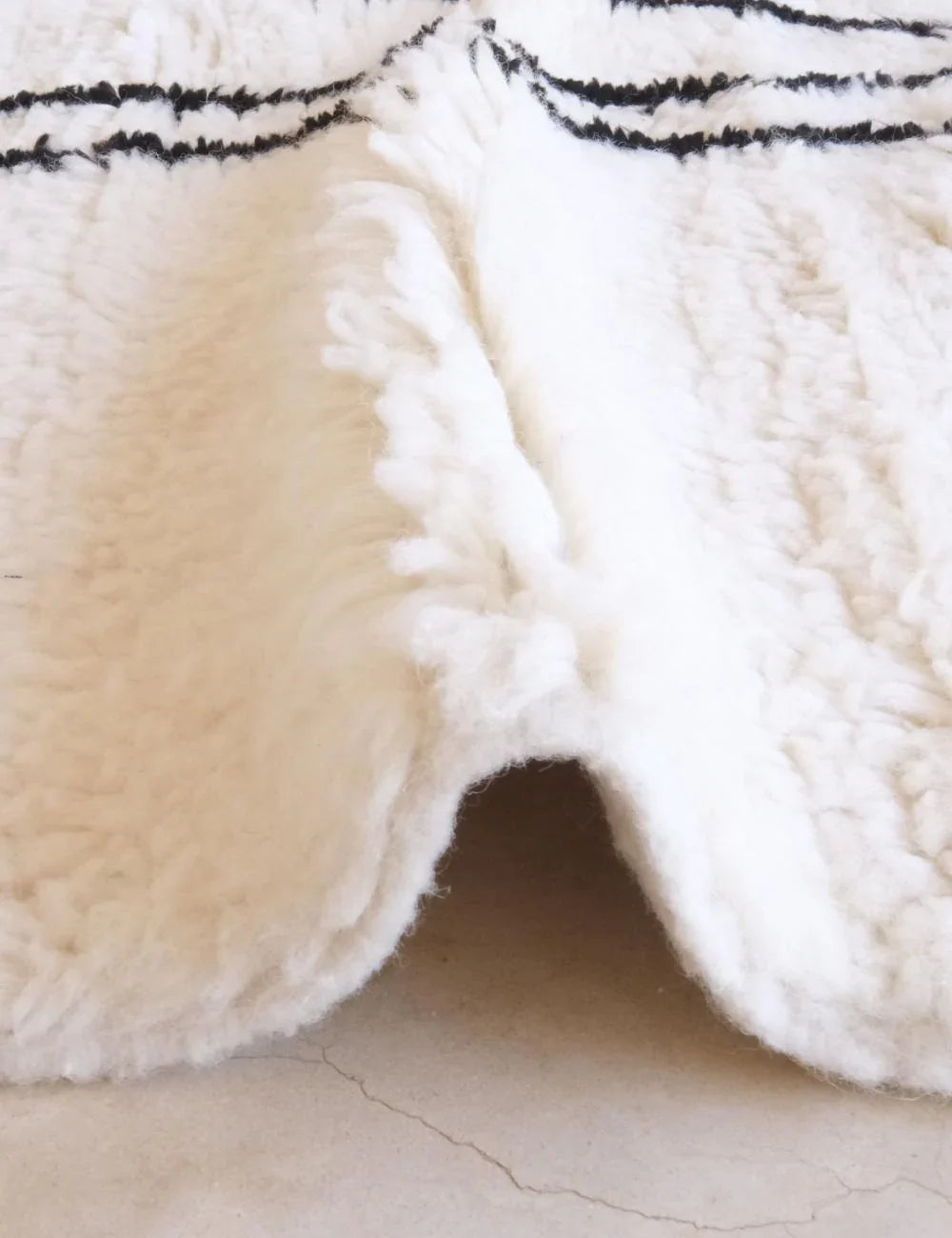 Close-up shot of the thick wool pile of a hand-knotted Beni M'rirt rug