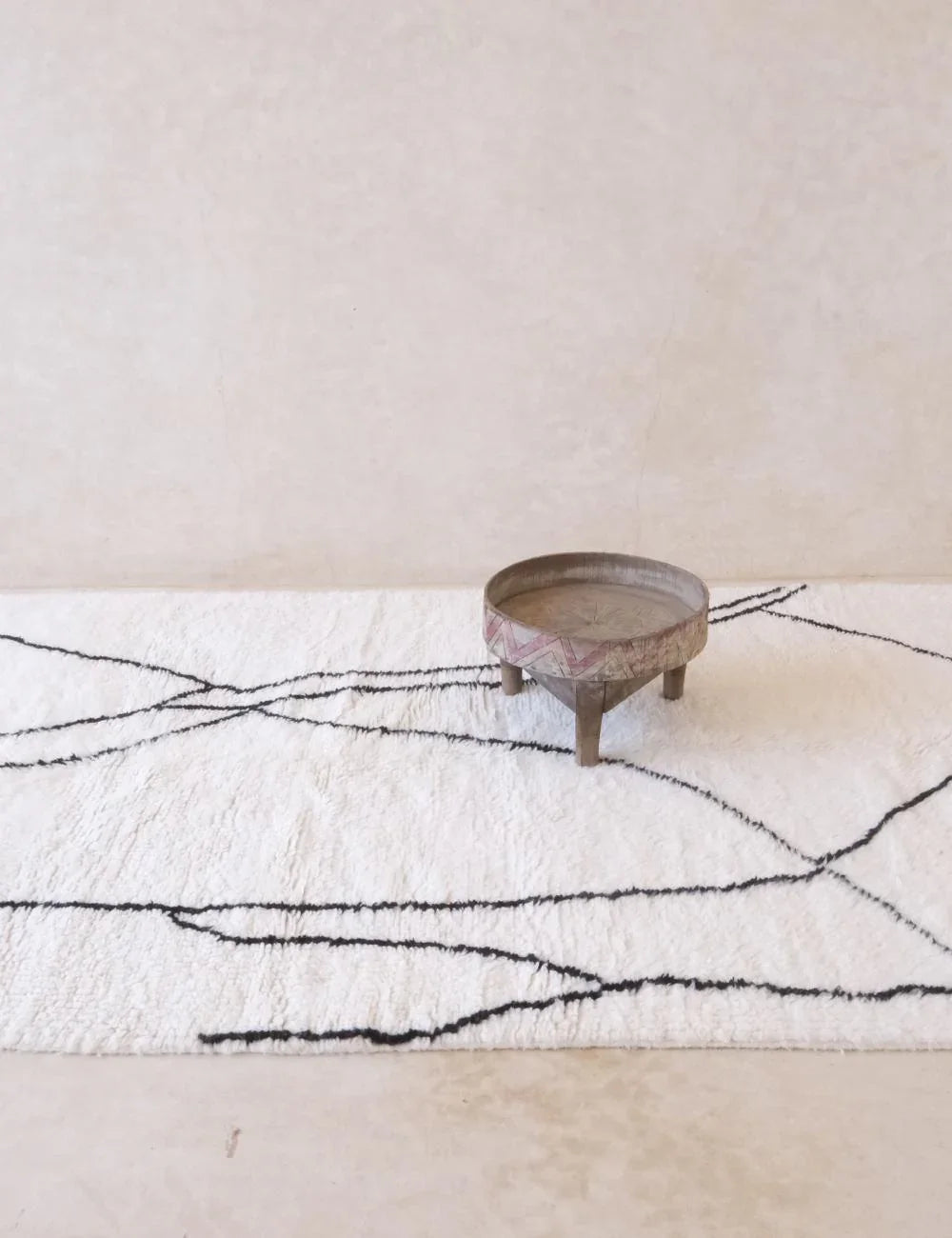 Cream and beige Beni M'rirt rug styled in a minimalist living room