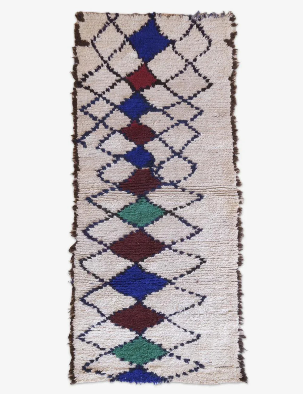 Woven rug with diamond pattern in various colors on a white background