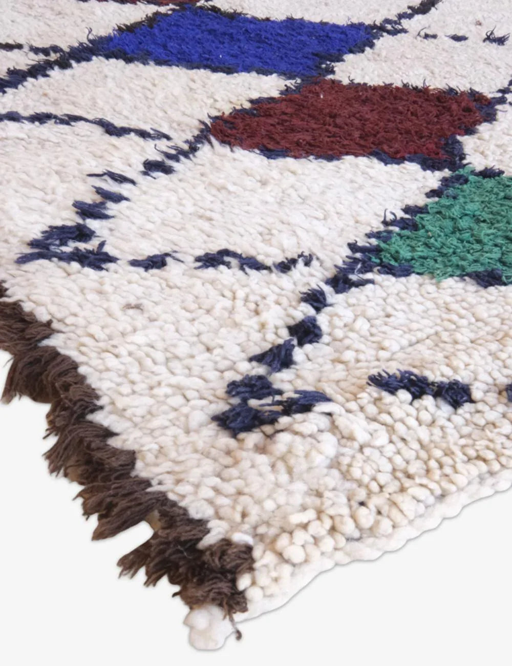 Close-up of a colorful woven rug with geometric pattern