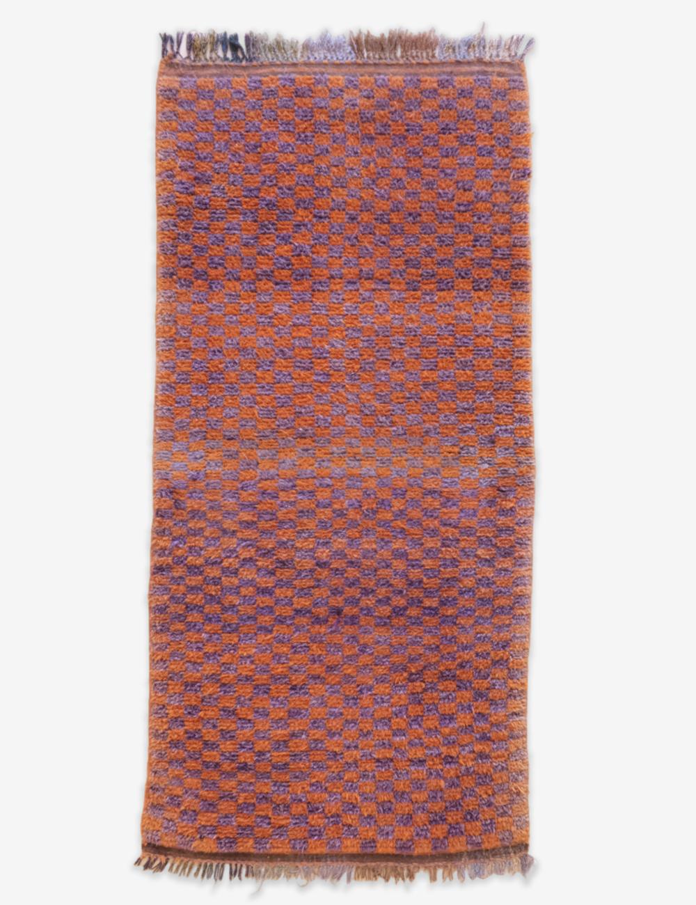 Woven rug with a geometric pattern on a white background