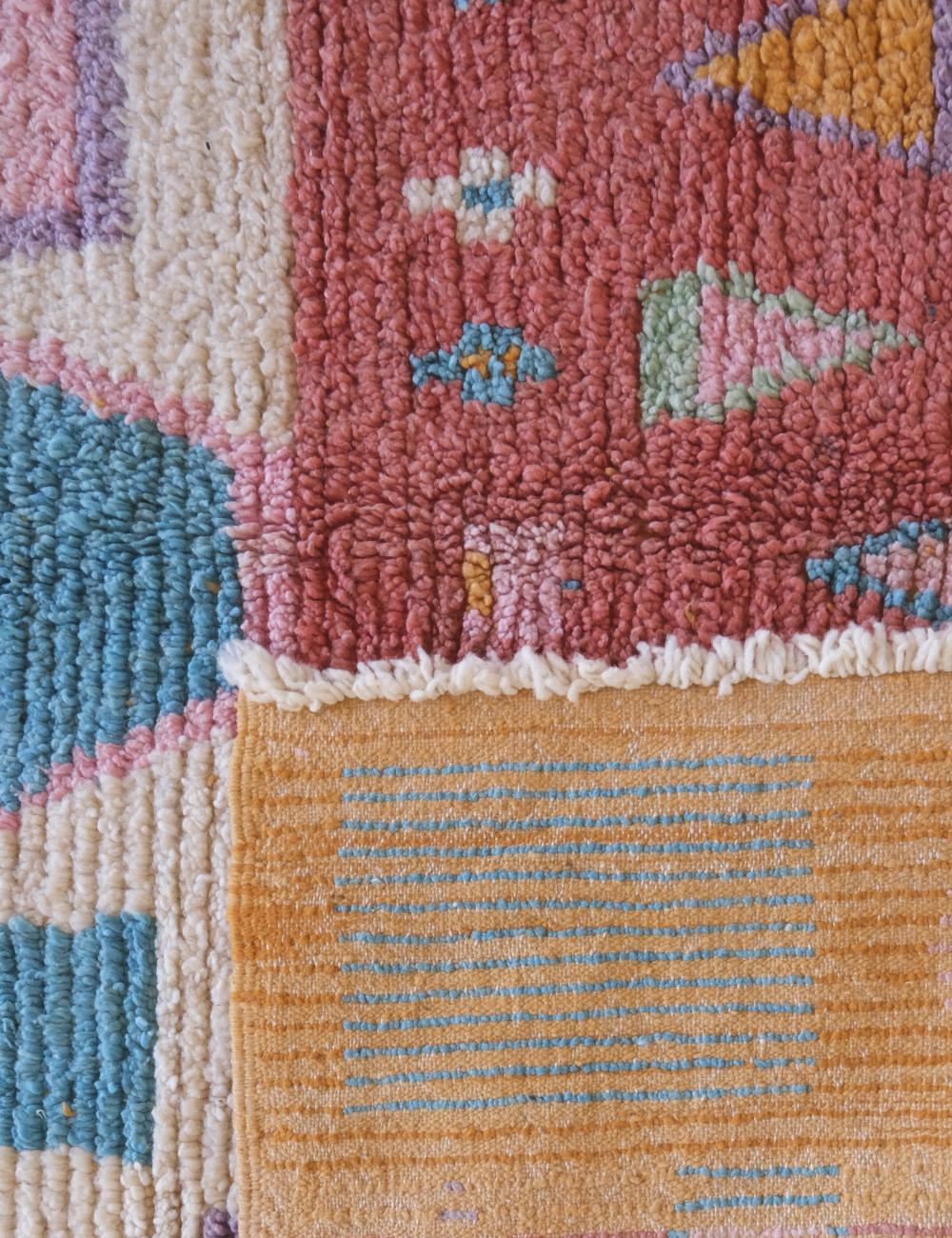 Close-up of a colorful patchwork rug with geometric patterns.