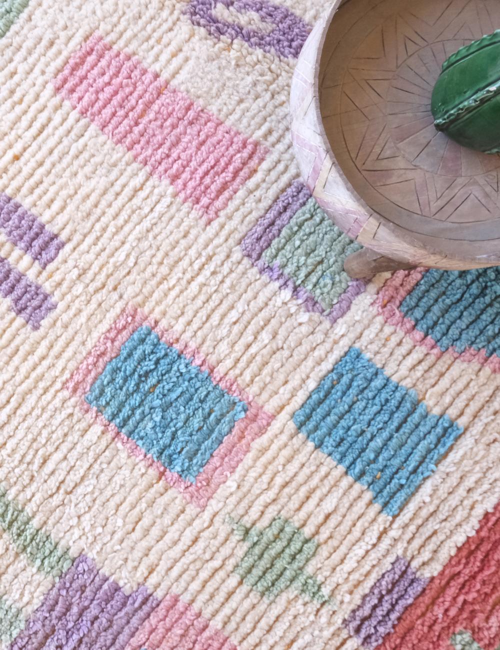 Close-up of a textured fabric with geometric pattern and a ceramic bowl.