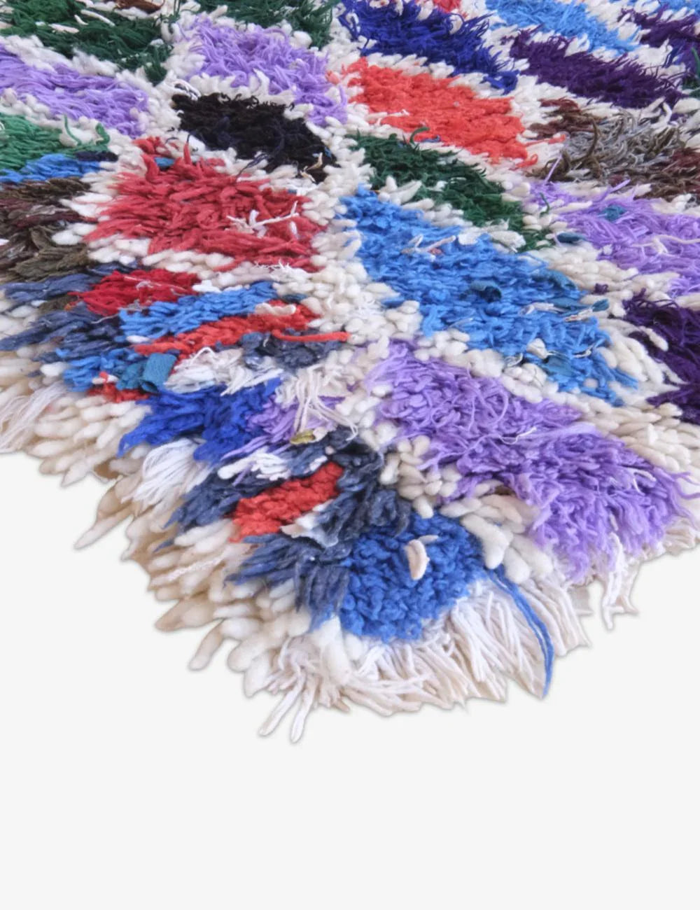 Multicolored textured rug with a circular pattern on a white background