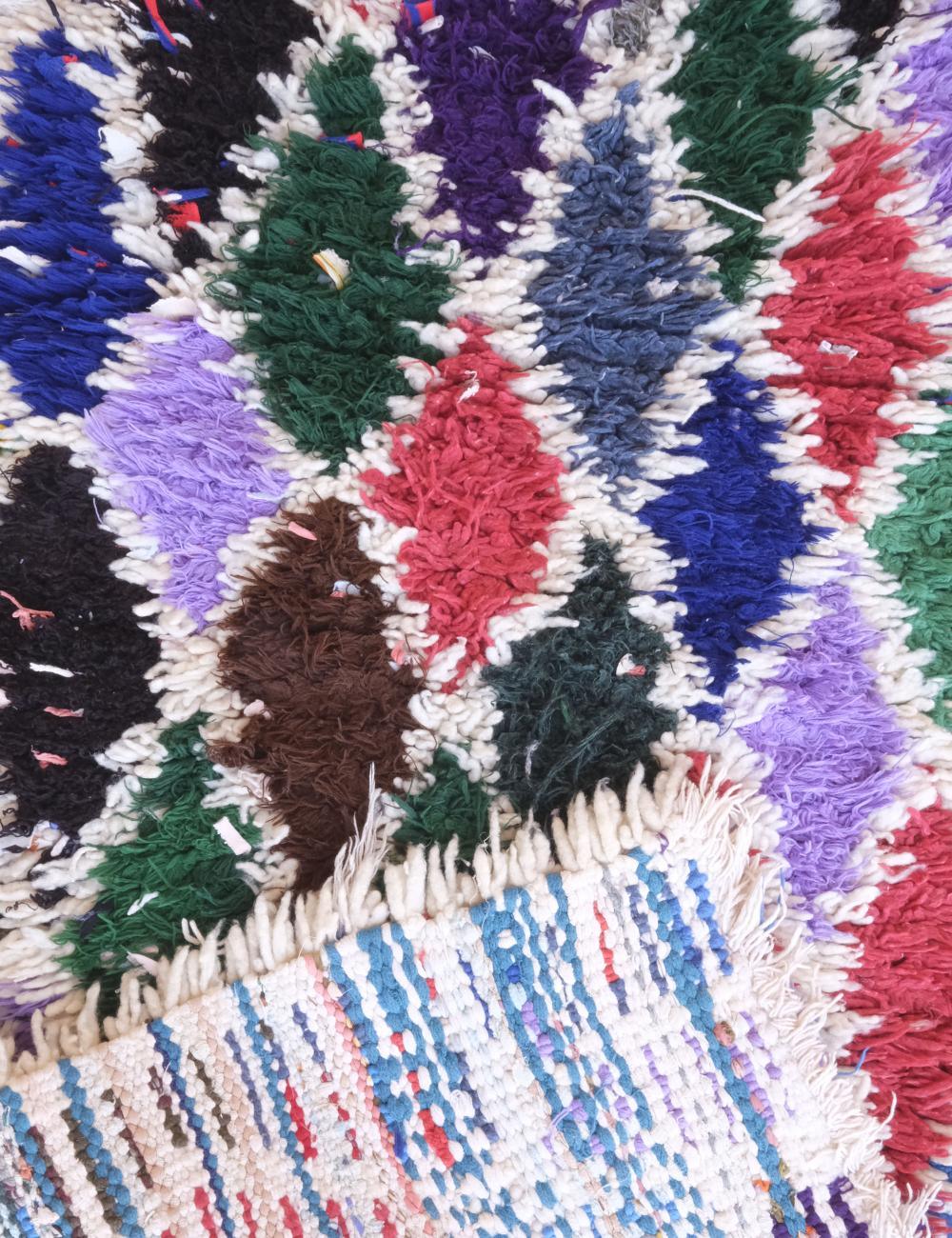 Multicolored textured fabric with a pattern of diagonal stripes.
