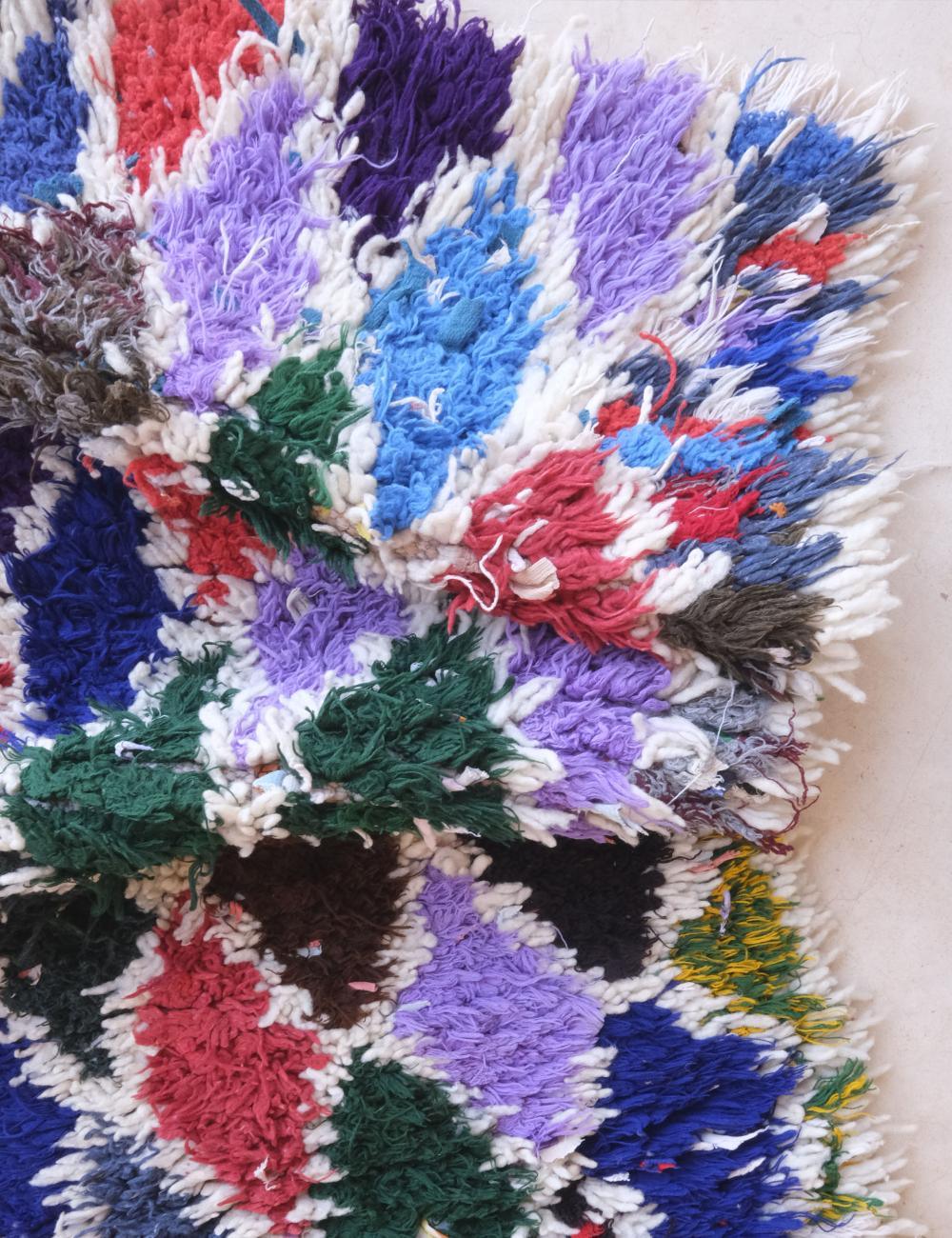 Colorful woven textile with a heart design on a white background