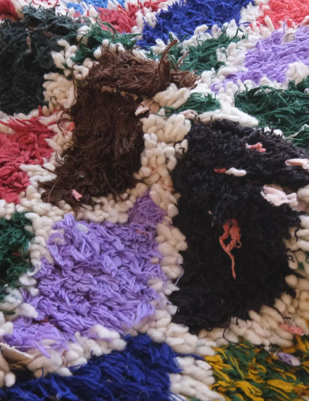 Close-up of a textured fabric with multicolored yarn patterns