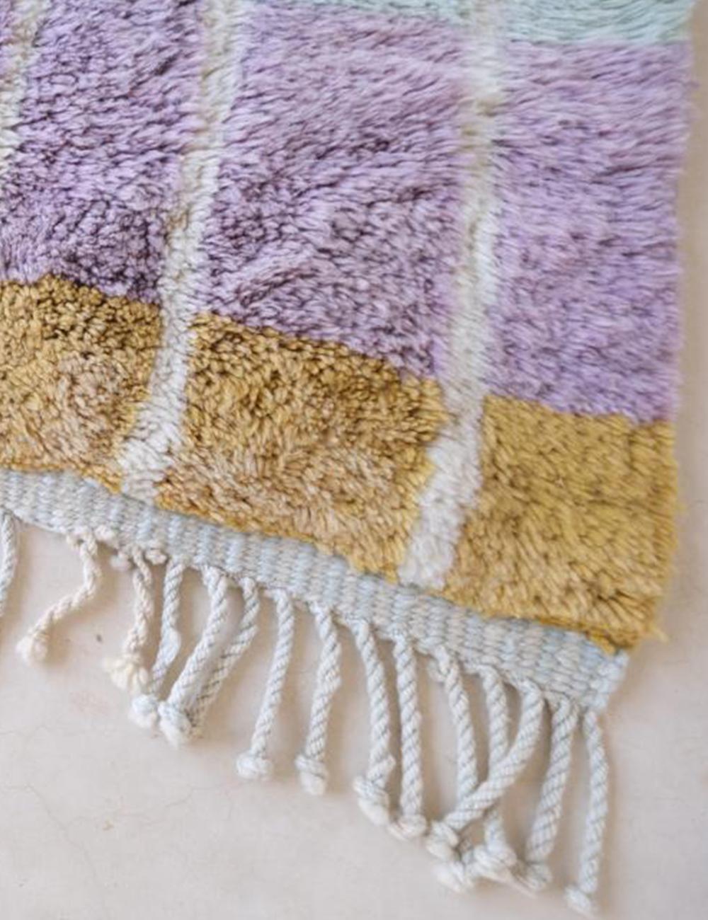 Contemporary Moroccan Beni Mrirt wool rug with pastel purple and golden yellow geometric design and white fringed tassels.