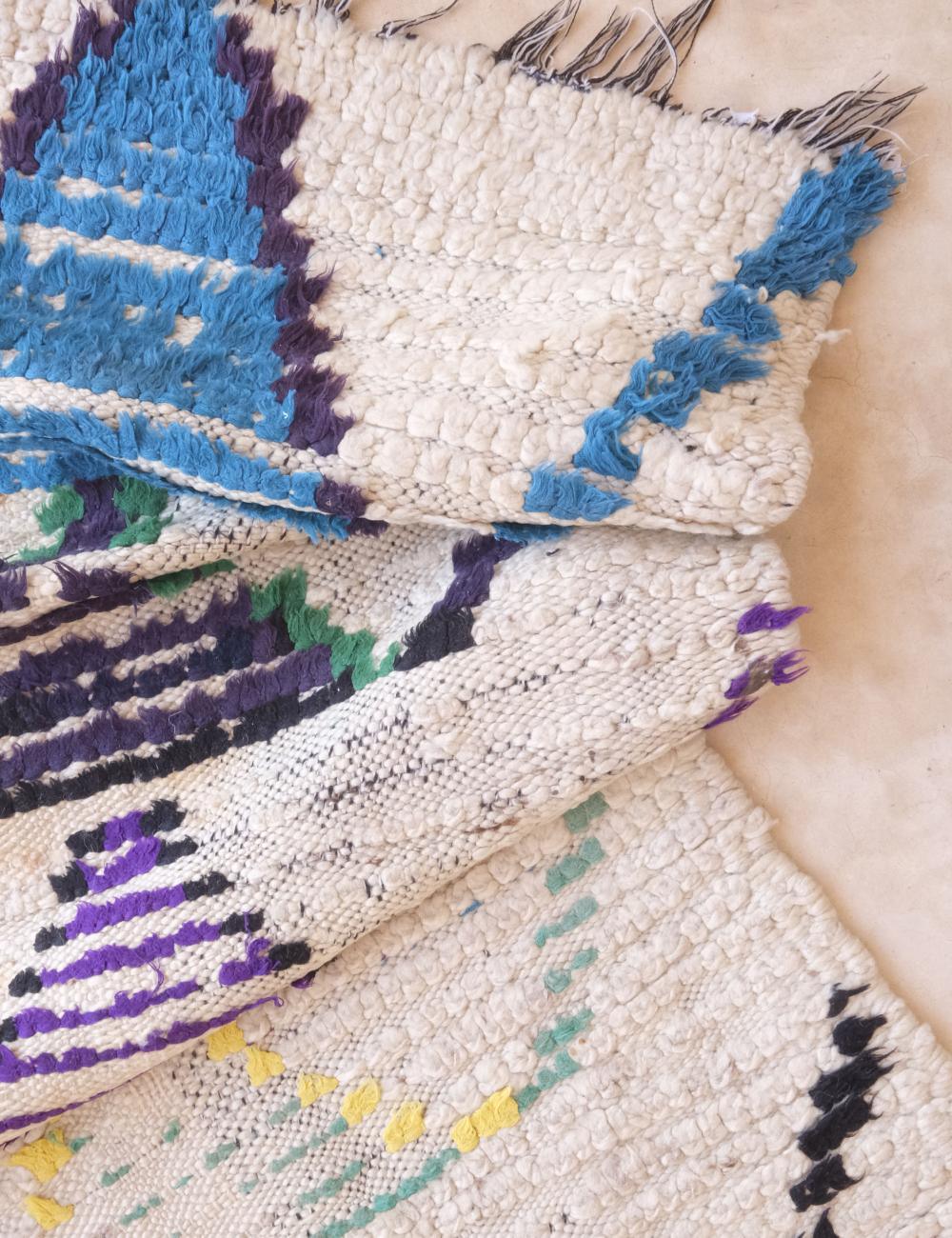 Close-up of a textured fabric with blue, purple, and white patterns.