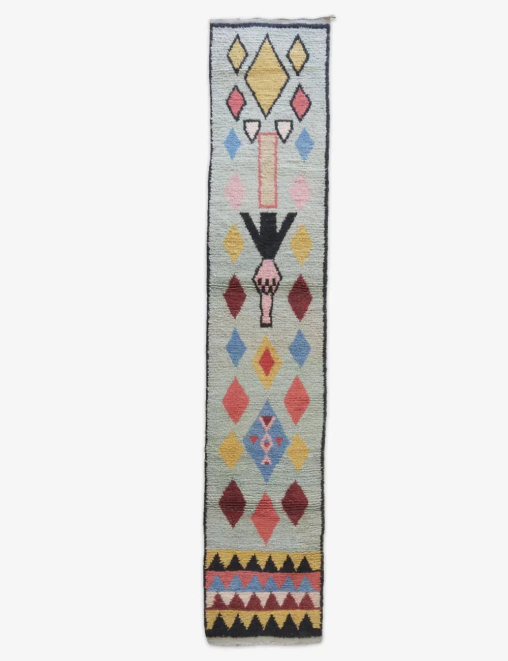 Colorful patterned rug with geometric design on a white background