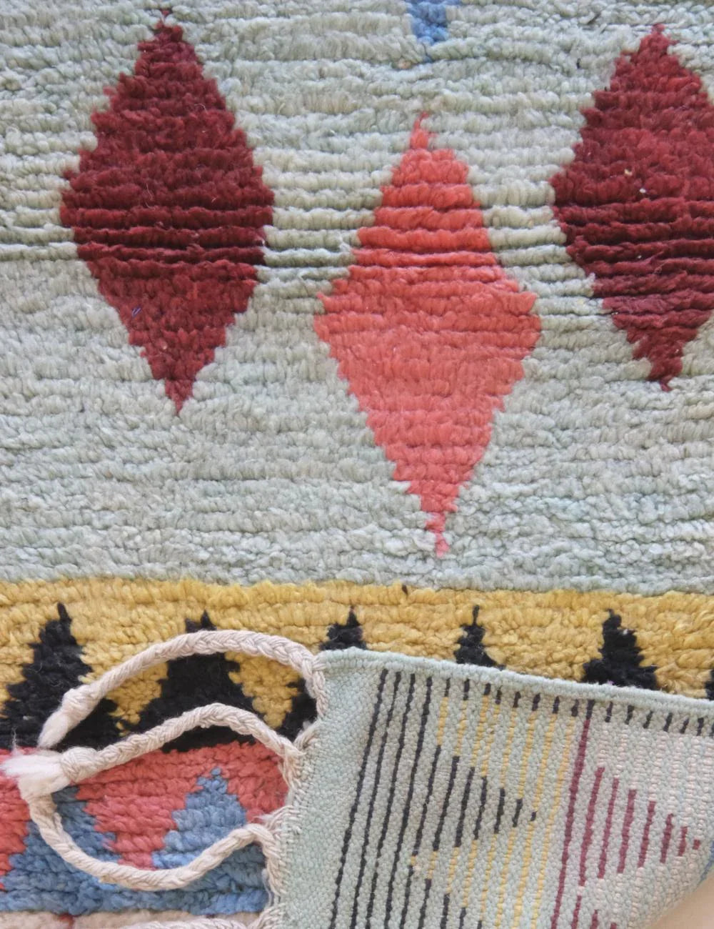 Close-up of a textured fabric with geometric patterns and a handle.