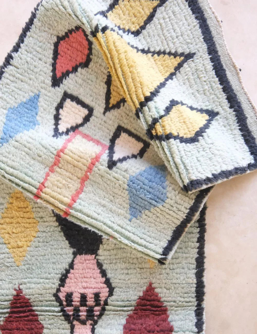 Geometric patterned fabric with colorful shapes on a light background
