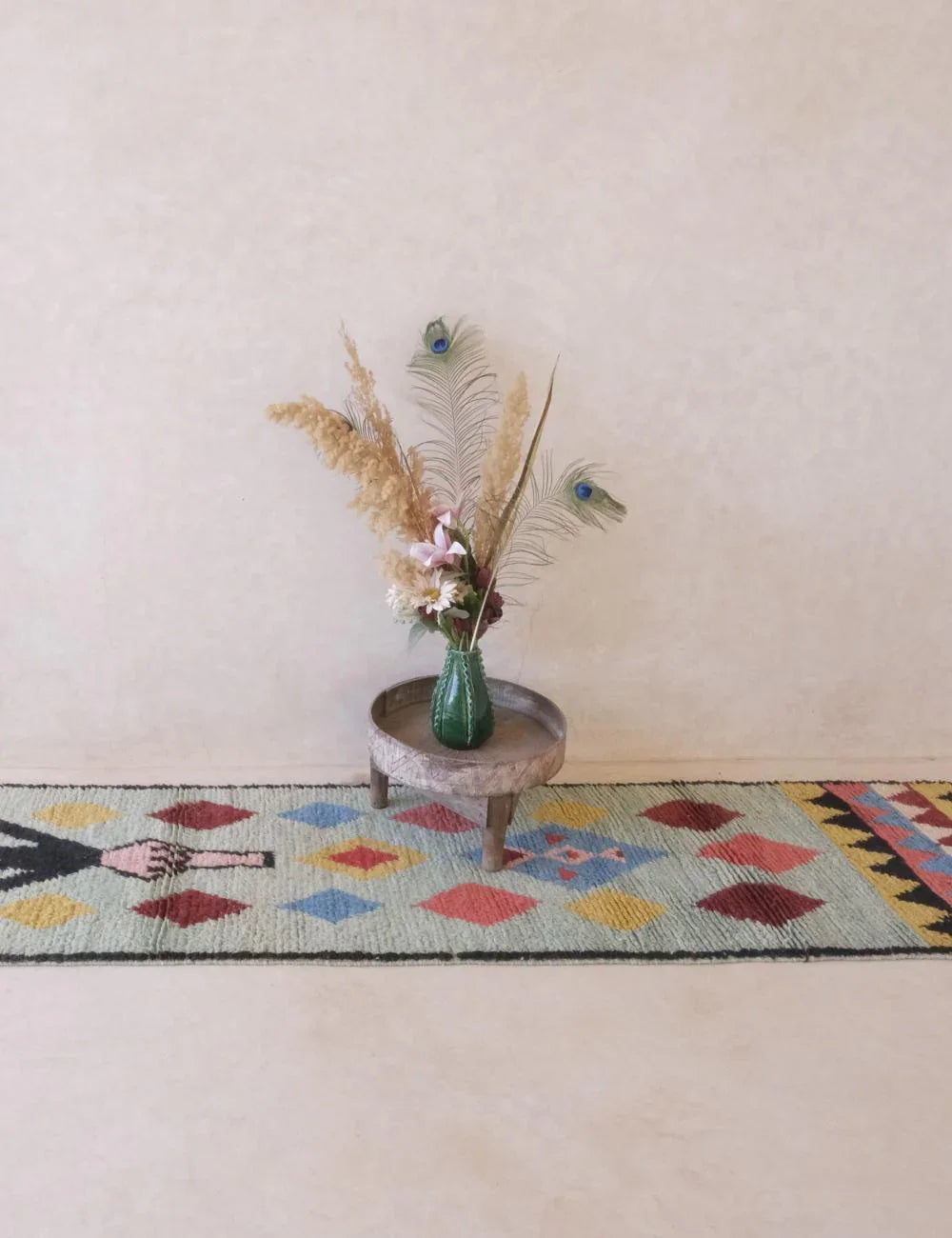 Decorative rug with geometric pattern on a plain wall background