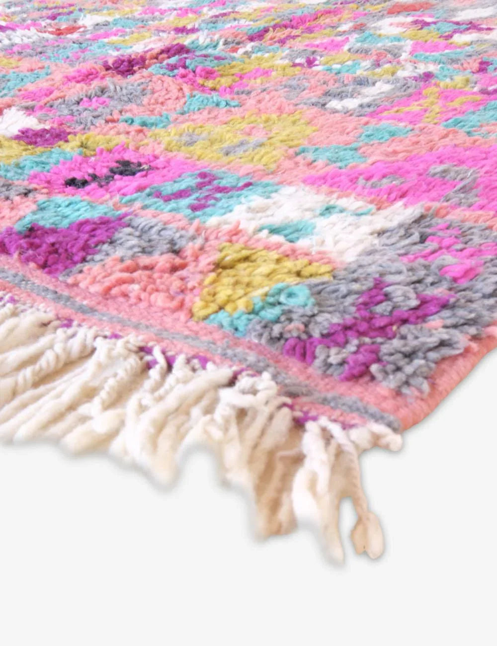 Colorful crocheted blanket with tassels on a white background