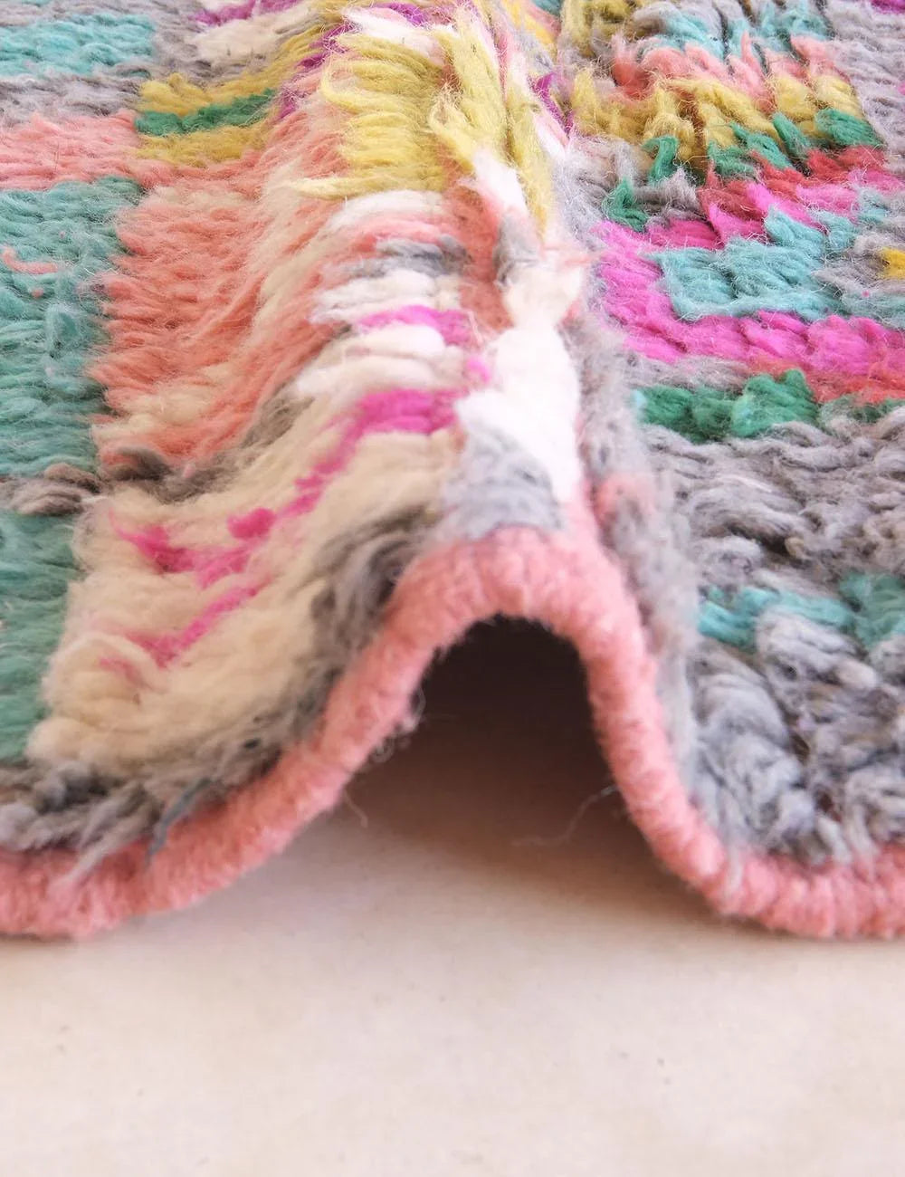 Close-up of a colorful textured fabric with a soft focus on a neutral background