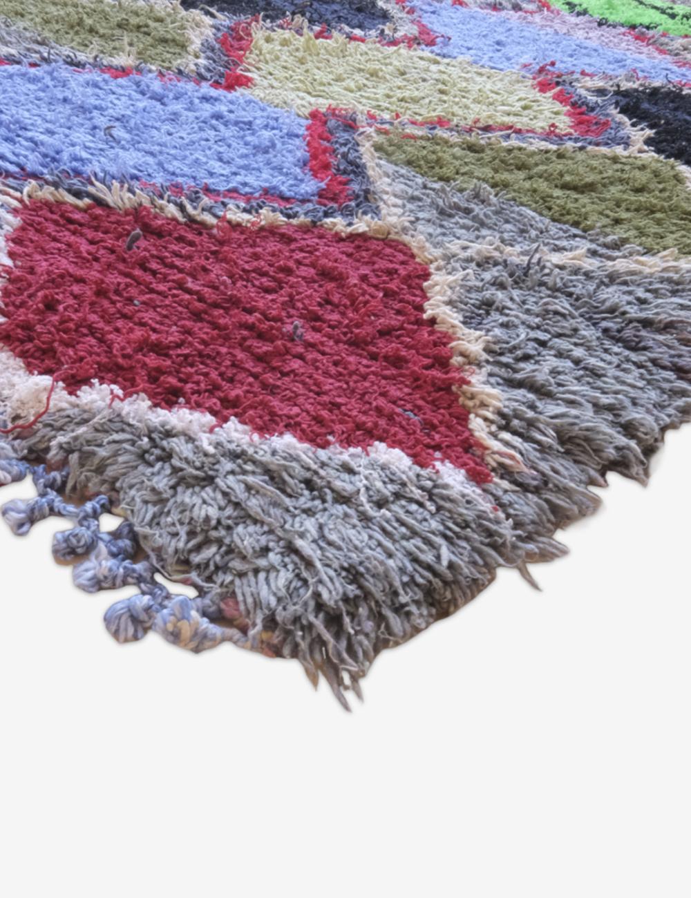 Multicolored shaggy rug with fringe on a white background