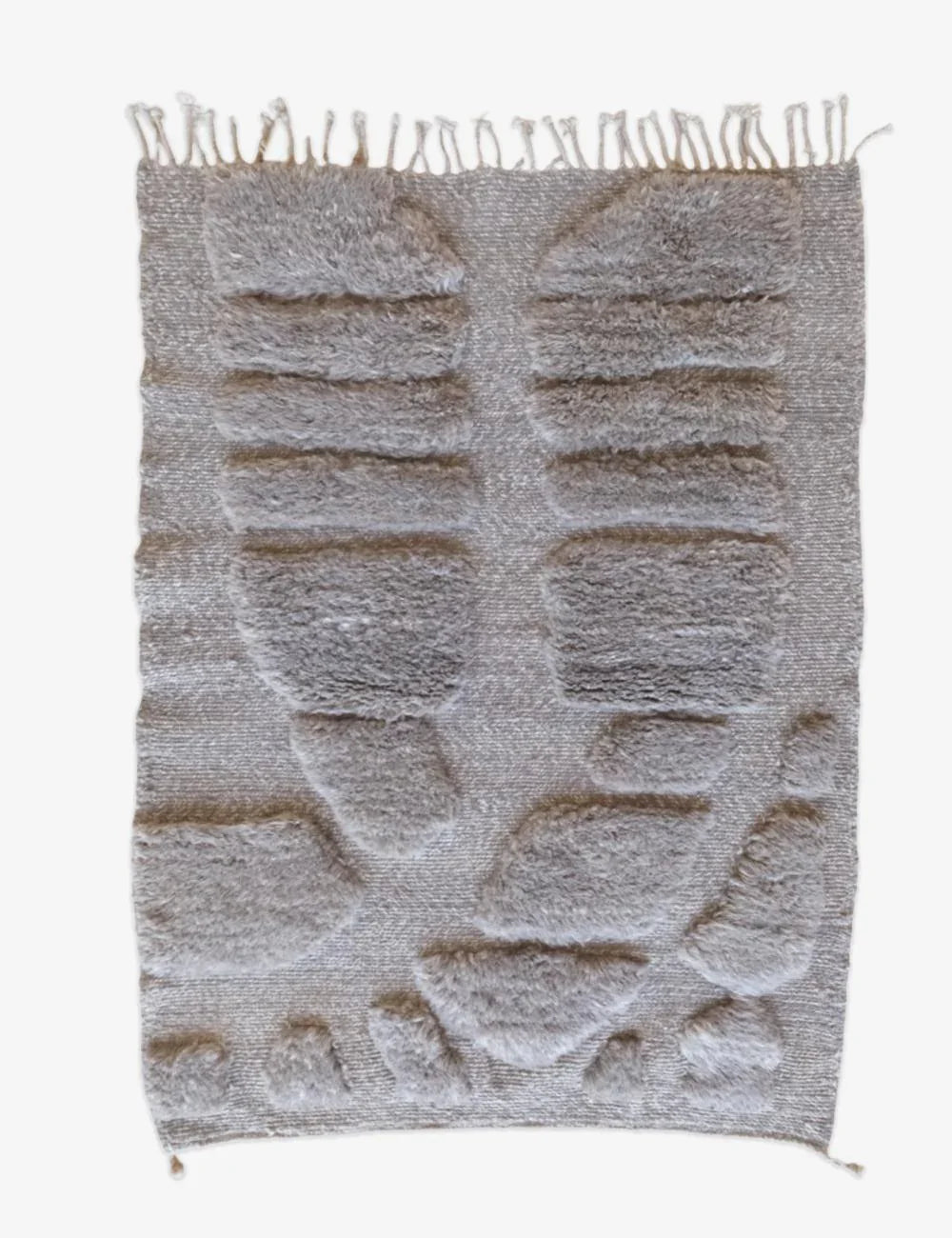 Textured woven rug with fringe on a white background