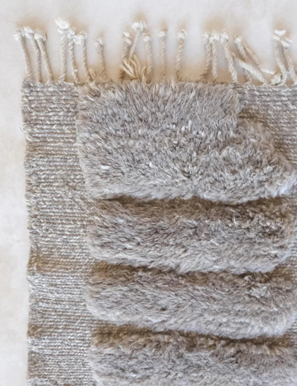 Close-up of a textured fabric with frayed edges on a light background