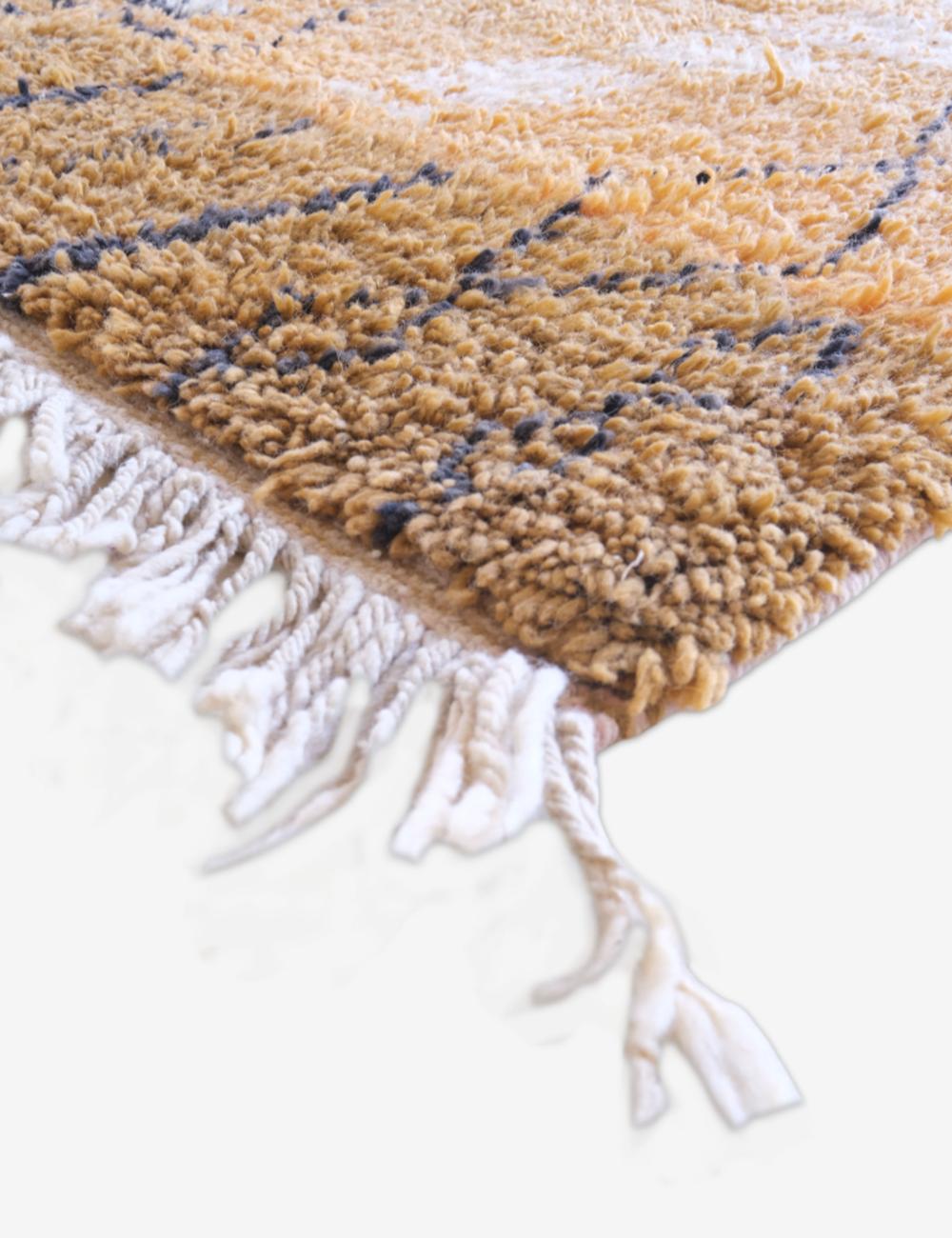 Textured rug with beige and brown pattern on a white background