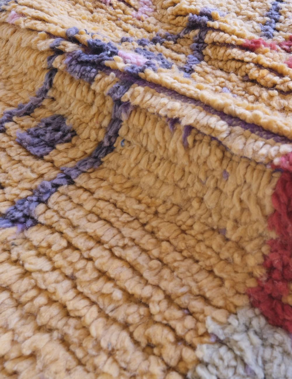 Close-up of a textured fabric with intricate patterns and colors.