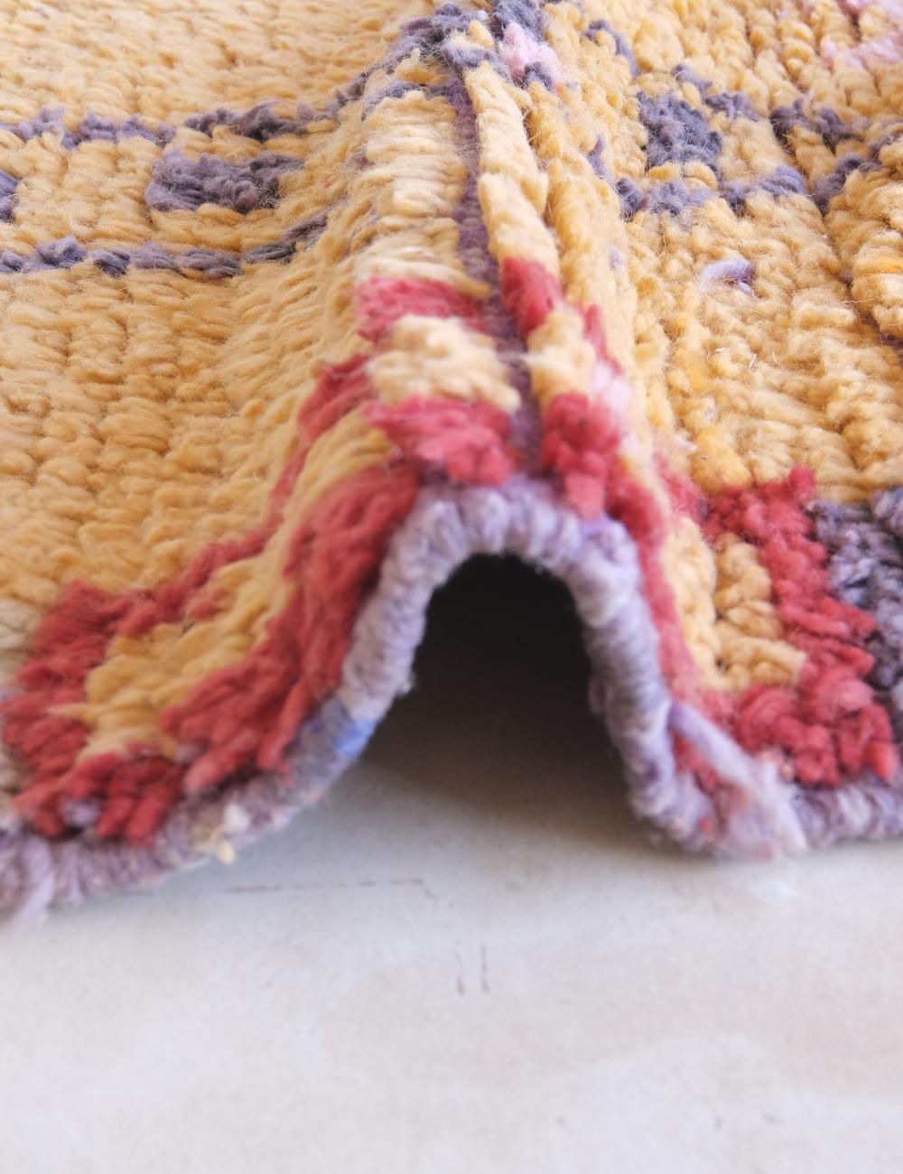 Close-up of a textured, multicolored fabric with a pattern.