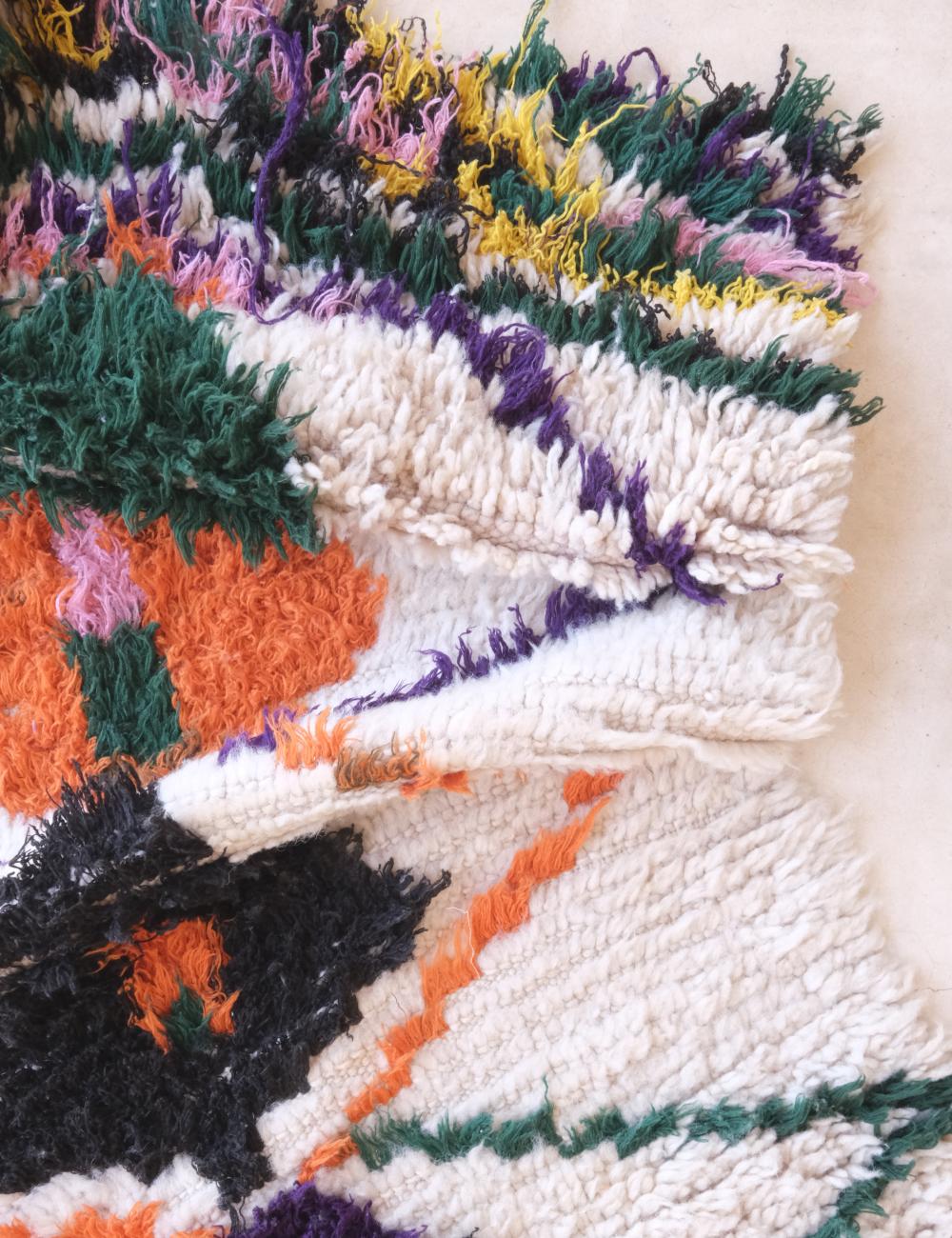 Close-up of a colorful woven textile with geometric patterns