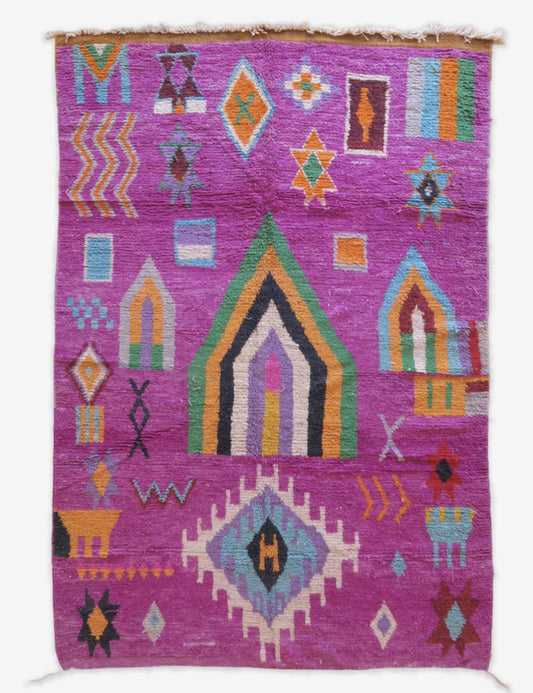 Colorful geometric patterned rug on a white background