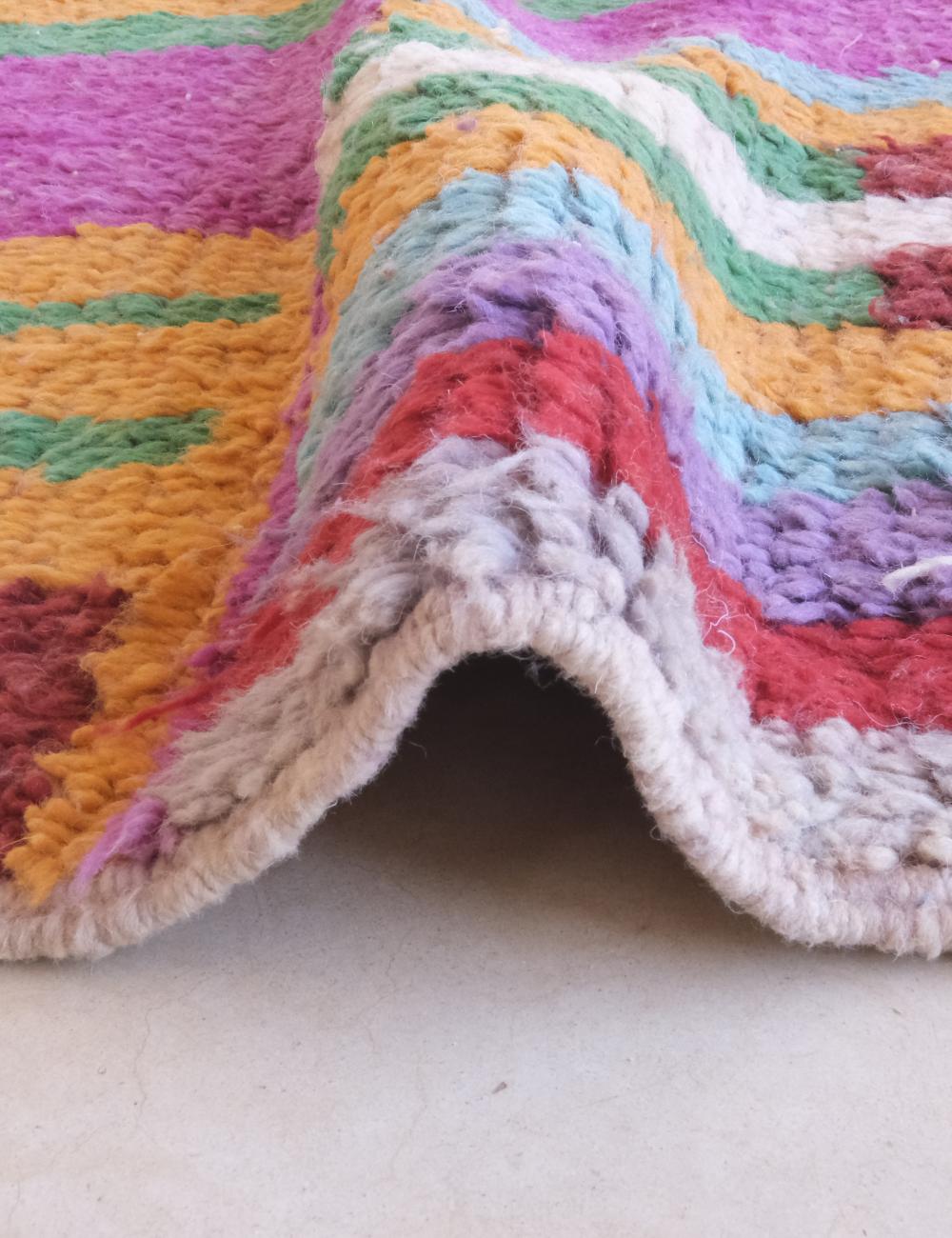 Close-up of a colorful textured fabric with a neutral border.