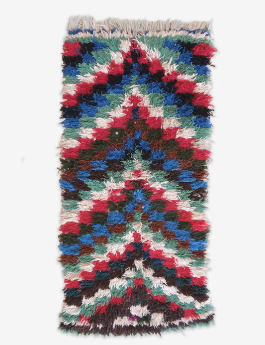 Multicolored woven rug with a geometric pattern on a white background