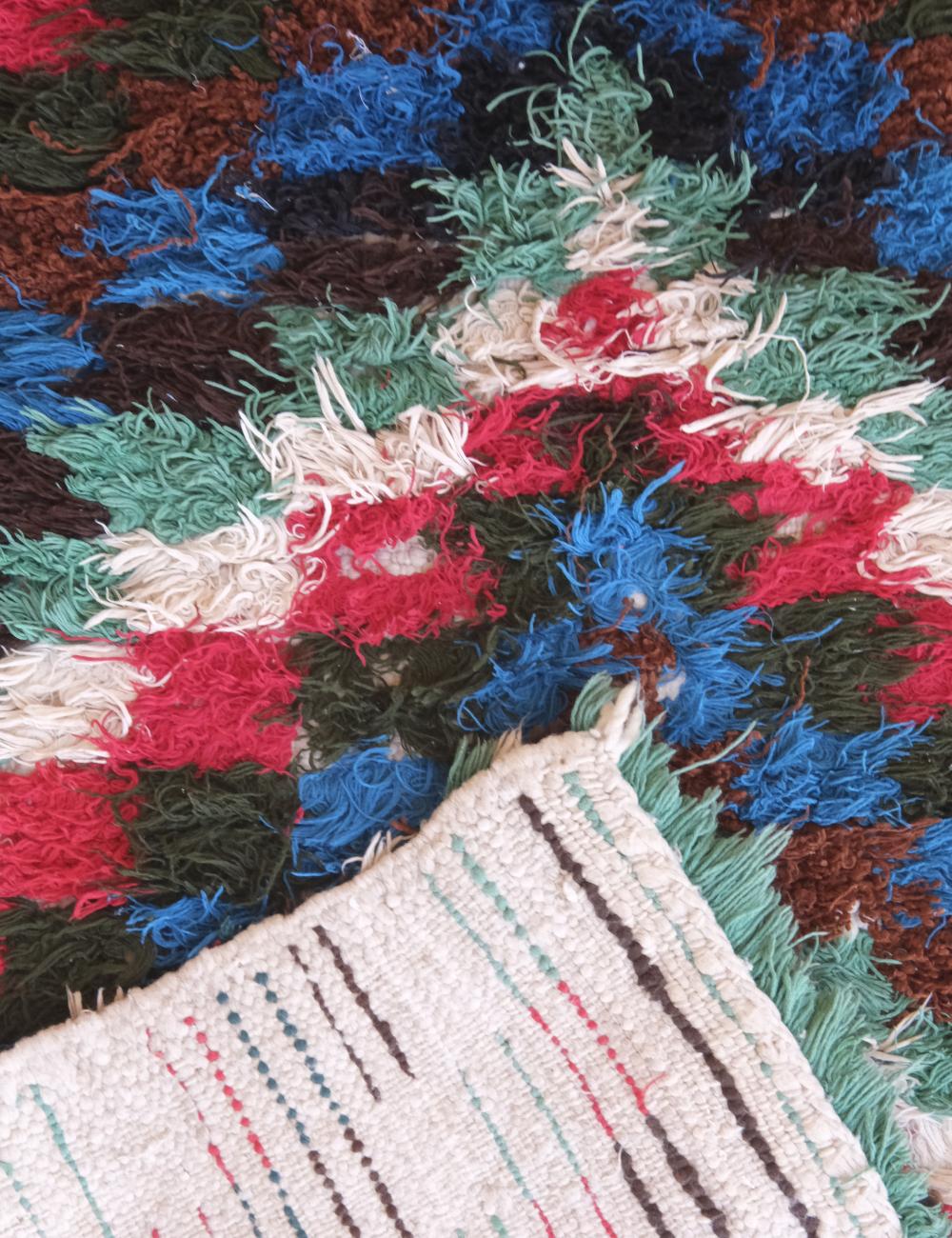 Close-up of a multicolored textured fabric with a geometric pattern.
