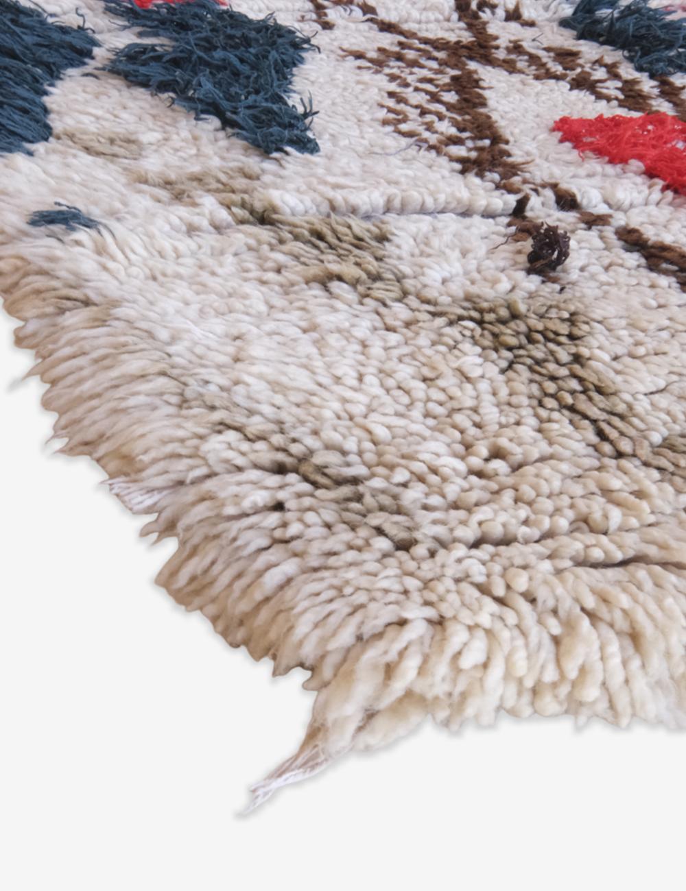 Close-up of a textured rug with a star pattern on a white background