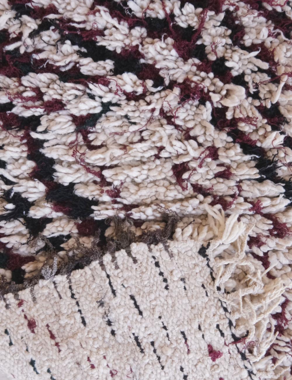 Close-up of a textured rug with a geometric pattern