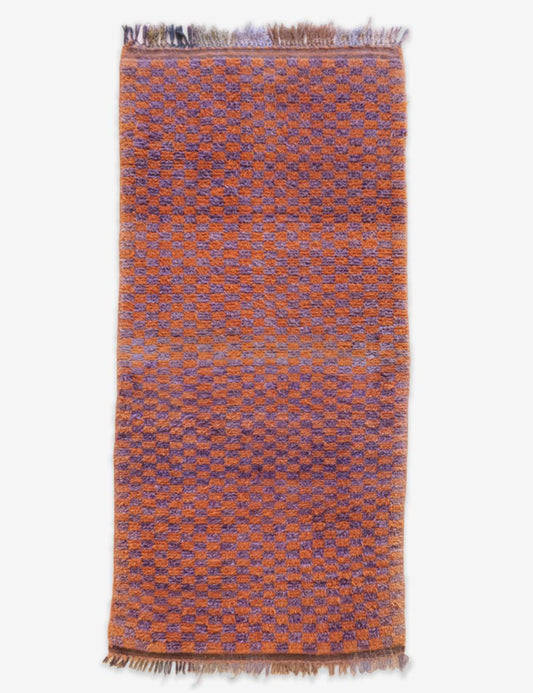 Woven rug with a geometric pattern on a white background