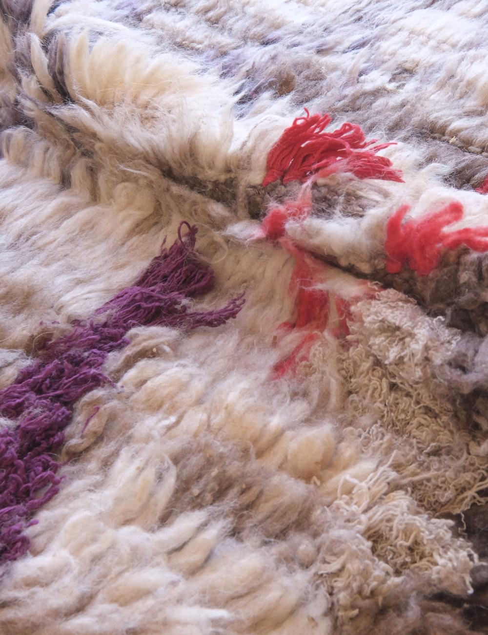 Close-up of textured fabric with colorful yarn strands
