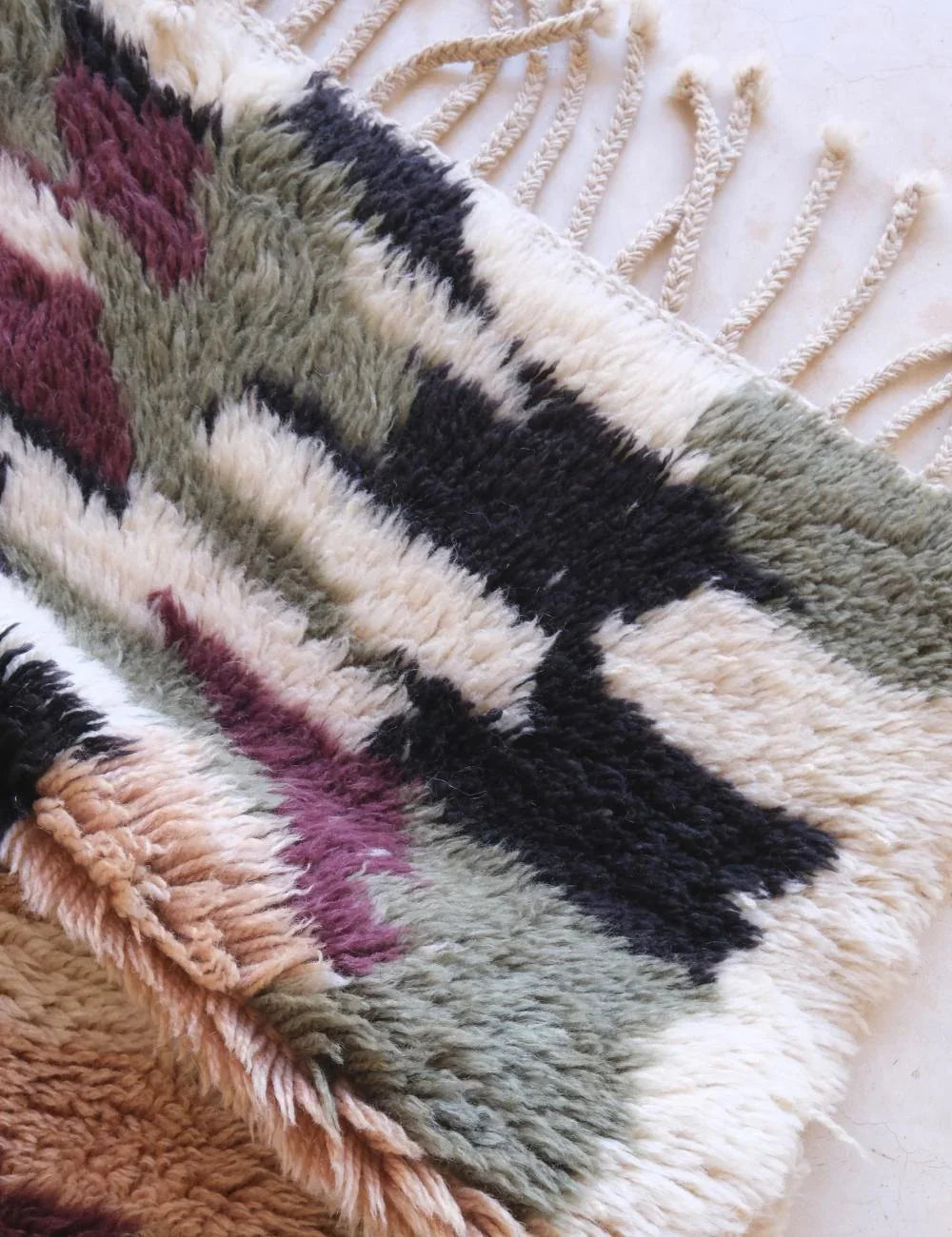 Close-up of a textured fabric with geometric pattern on a neutral background