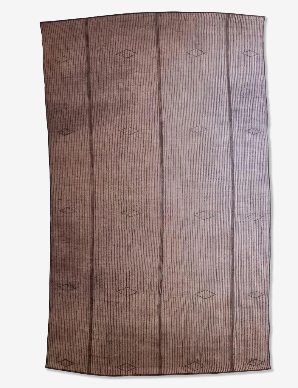 A rectangular woven rug with a brown and beige striped pattern, featuring vertical bands and small diamond motifs, shown flat against a light background.