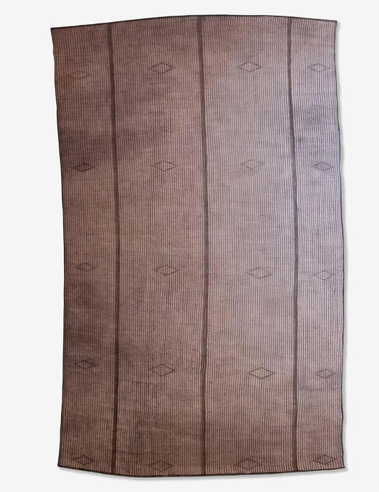 A rectangular woven rug with a brown and beige striped pattern, featuring vertical bands and small diamond motifs, shown flat against a light background.